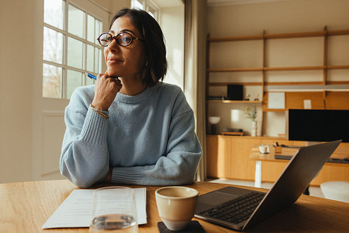 Woman works on a laptop in a Scandinavian office