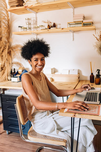 Smiling woman accessories designer in studio