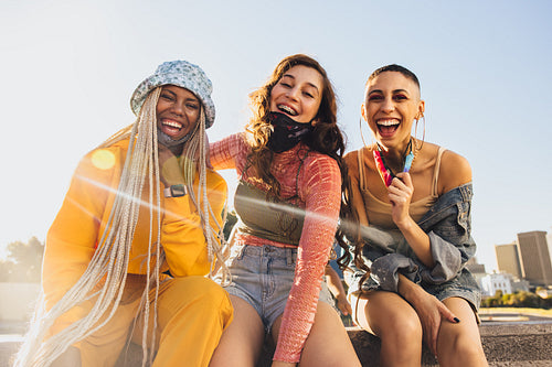 Friends having fun while wearing face masks
