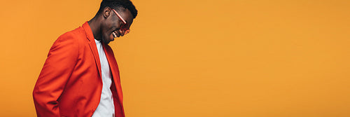 Handsome african fashion model on orange background