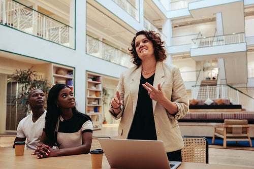 Confident businesswoman in a professional meeting in a modern office space with neutral tones