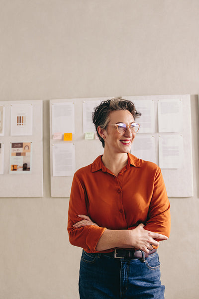 Interior designer looking away with a happy smile in her office