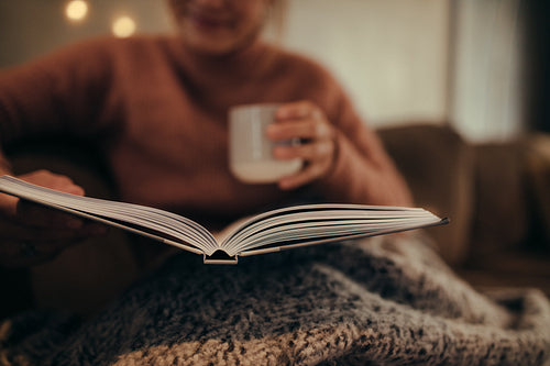 Woman reading book at home
