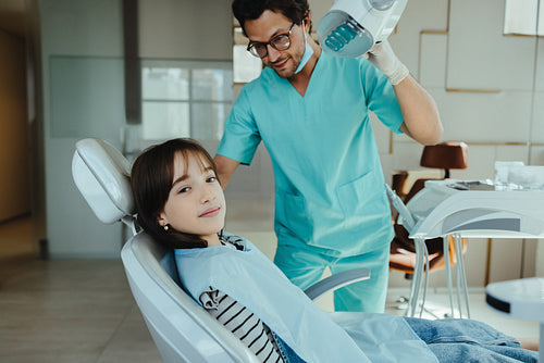 Young girl in dentist chair ready for her dental exam
