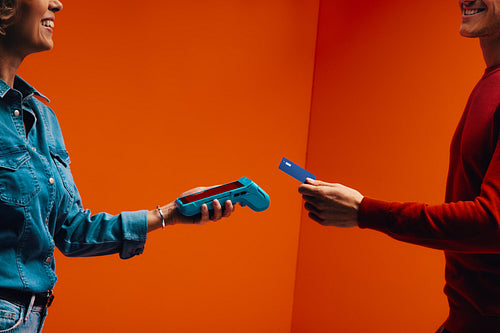 Tap to pay technology for seamless shopping transaction in orange monochromatic set