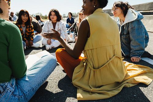 Multicultural group of people peacefully gathered outdoors for demonstration and discussion