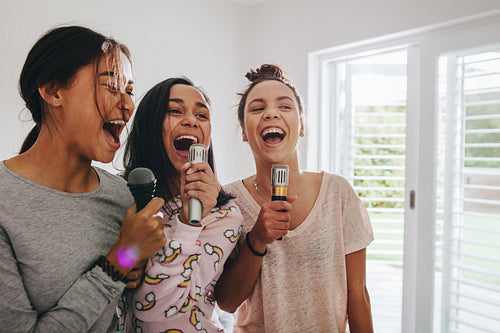 Girls singing karaoke at a sleepover