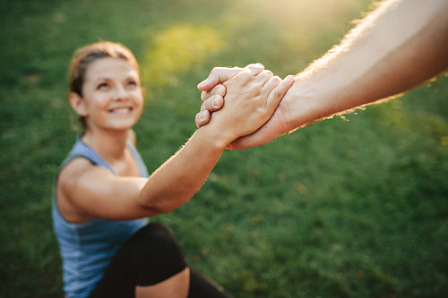 Man helping woman to stand up