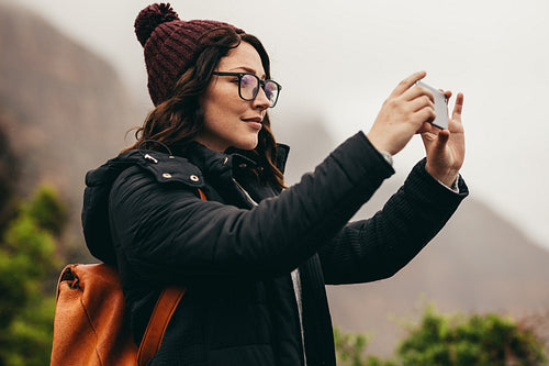 Female tourist capturing the landscape in her phone