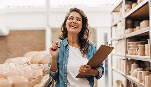 Successful female ceramist thinking of new ideas for her shop