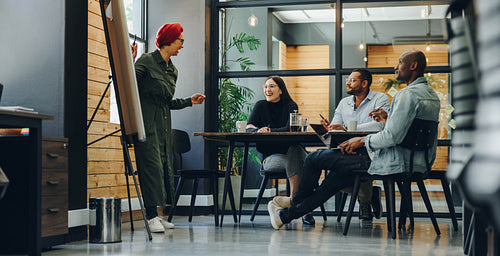 Female team leader giving a presentation during an office meetin