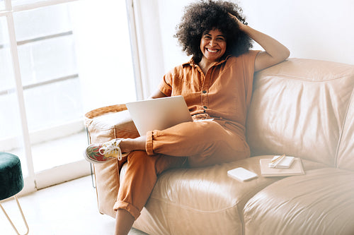 Cheerful black businesswoman smiling at the camera in an office lobby