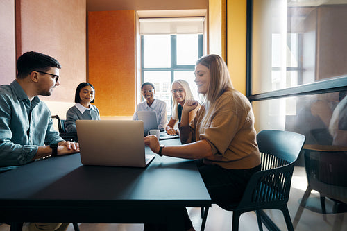 Diverse team engaged in a collaborative meeting in a modern office setting