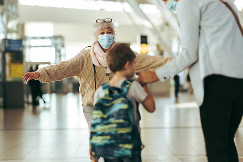 Grandmother welcoming her family at airport