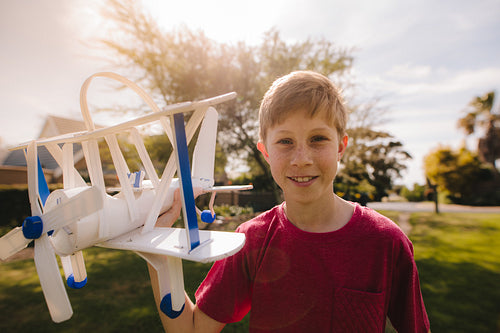 Happy young boy with a toy plane