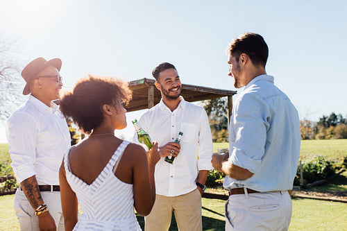 Group of multiethnic friends drinking and socialising