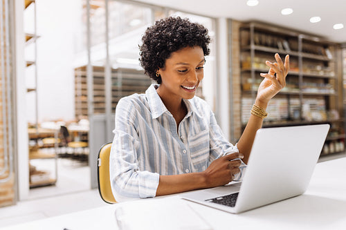 Creative businesswoman having a video call in a warehouse