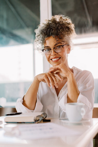 Confident businesswoman sitting in a cafe