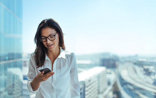 Young businesswoman using her mobile phone.