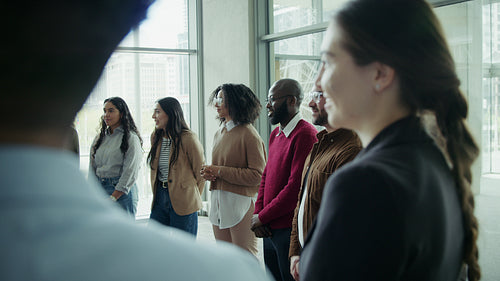 Diverse group attentively listening in office