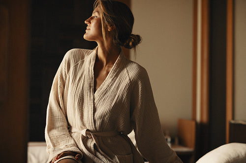 Woman in bathrobe enjoying relaxation and comfort in a tranquil setting
