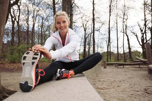 Happy young lady working out in nature