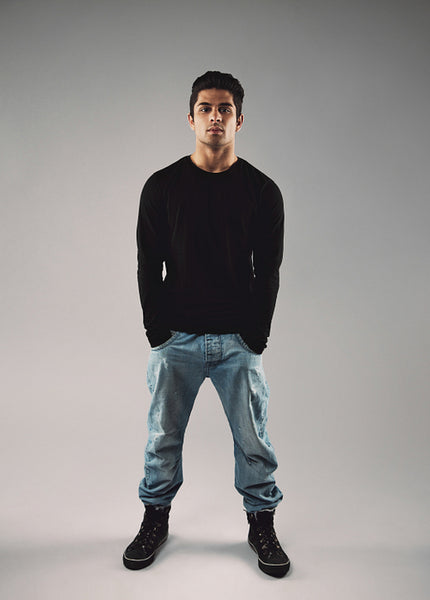 Stylish young man in casuals on grey background