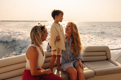 Contented family sharing a luxury yacht vacation at sunset