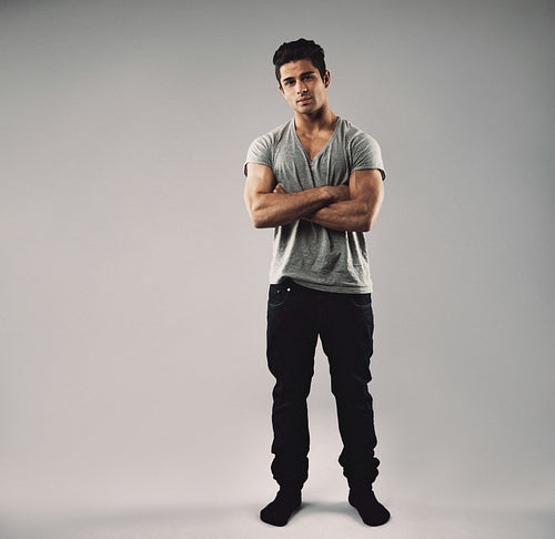 Muscular young guy posing confidently