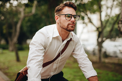 Close up of a businessman riding a bike