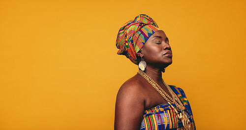 African woman wearing traditional clothing in a studio