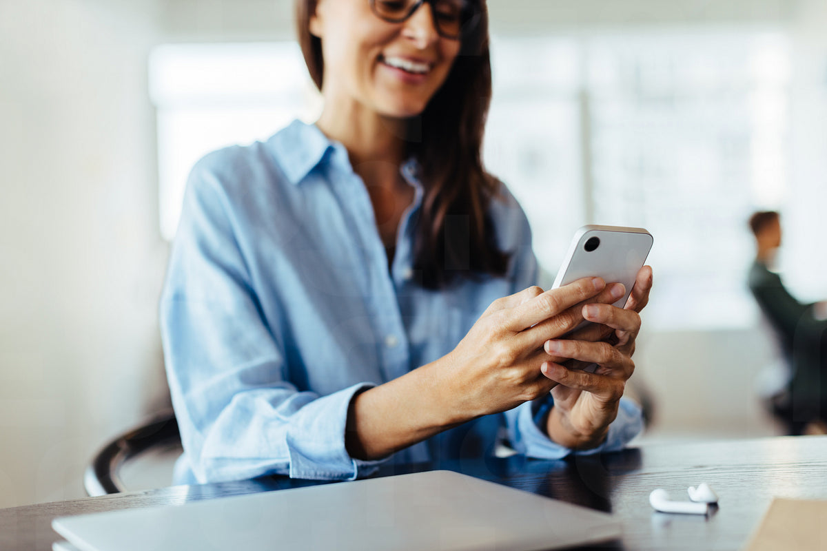 Professional woman using a cell phone in an office – Jacob Lund ...
