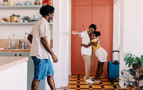 Reunion after a trip: Mother getting a warm welcome from her daughter and husband