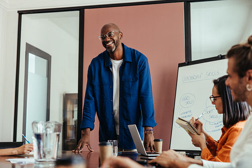 Man leading seminar on leadership skills in a modern boardroom