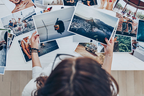 Photographer looking at prints in studio