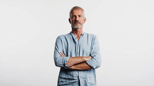 Senior man standing with arms crossed