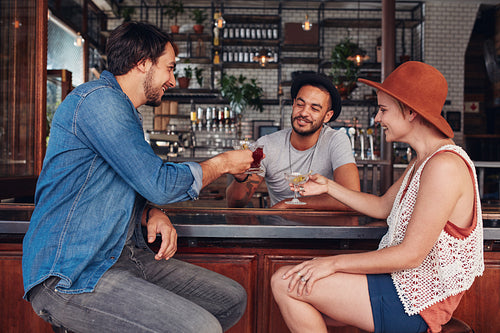 Young modern people in coffee shop having drinks