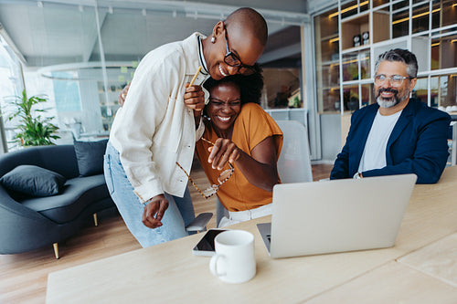 Successful businesswomen in a modern office celebrating a project