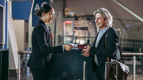 Man check-in at the airport with his passport and boarding pass