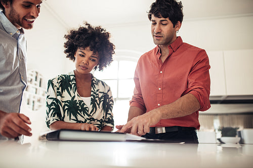 Male broker presenting contract papers owners couple.