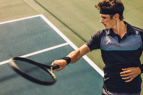 Tennis player hitting forehand from baseline