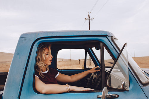 Woman driving a truck on country road