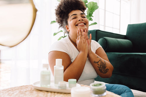 Healthy woman applying facial cream