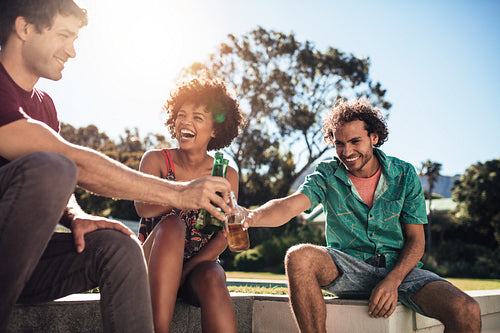 Friends having fun with drinks outdoors