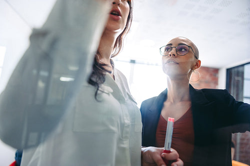 Confident businesswomen brainstorming in an office