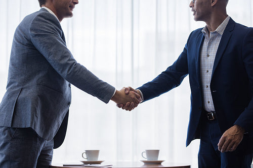 Business men shaking hands with each other after a deal
