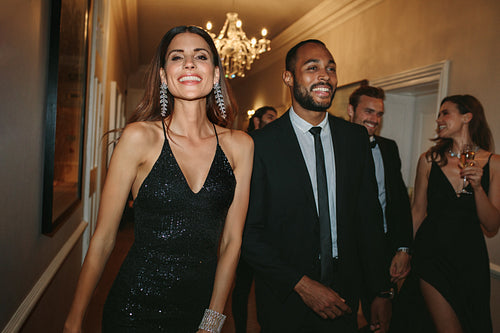 Group of people walking through nightclub corridor