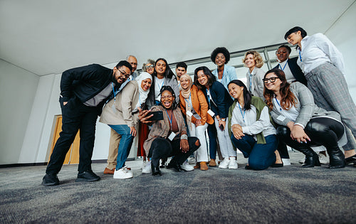 Diverse group of happy business people taking a selfie at a conference