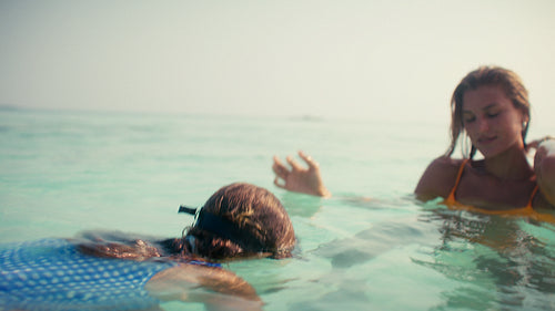 Mother and daughter enjoying a luxurious tropical vacation together at a beautiful beach resort