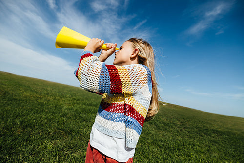 Girl expressing imagination through playful storytelling outdoors